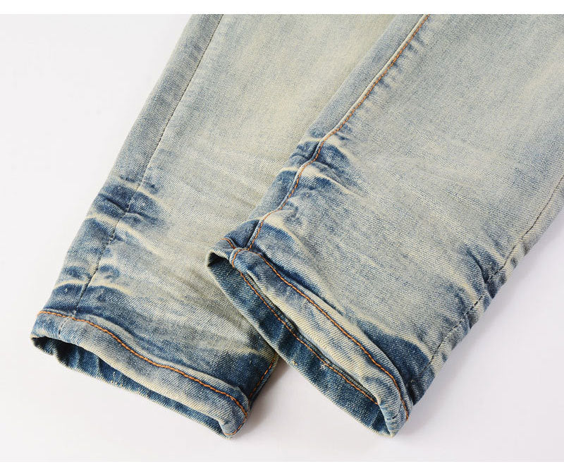 Men's light blue slim fit ripped patches jeans with distressed details and slight stretch