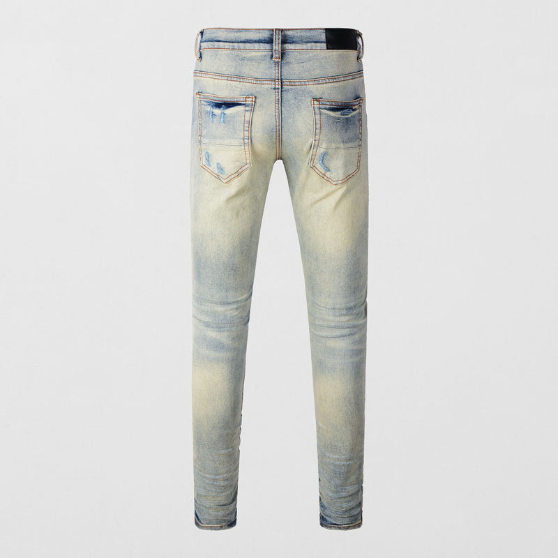 Men's light blue ripped patches jeans with slim fit and distressed detailing
