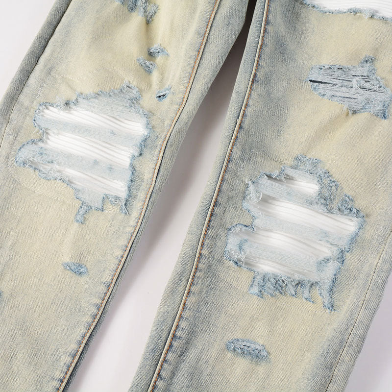 Light blue slim fit men's ripped patches jeans with distressed details and slight stretch.