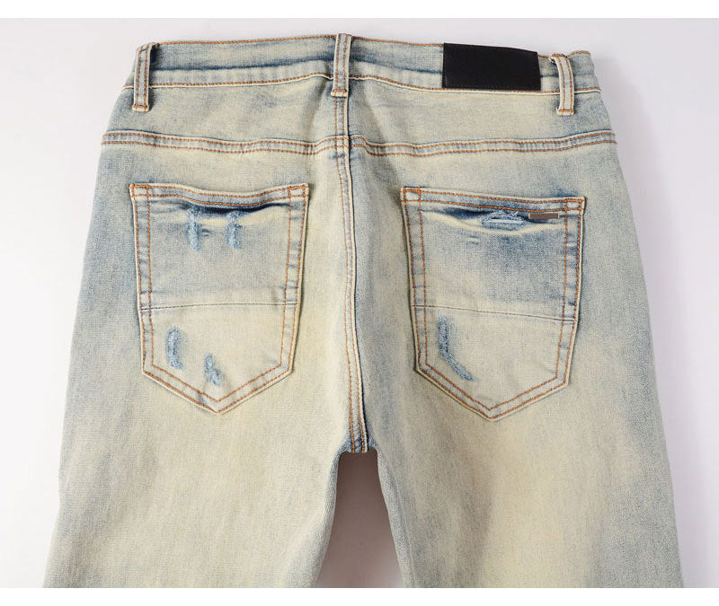 Men's light blue ripped patches jeans with slim fit and distressed details