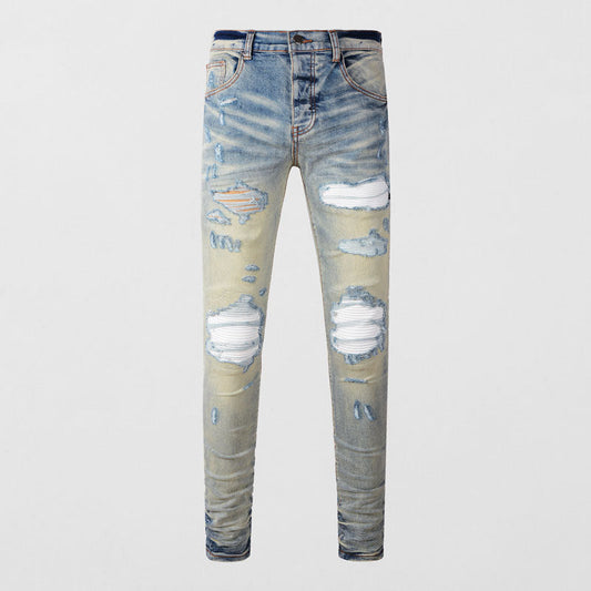 Men's light blue slim fit ripped patches jeans with distressed details and stretchy fabric